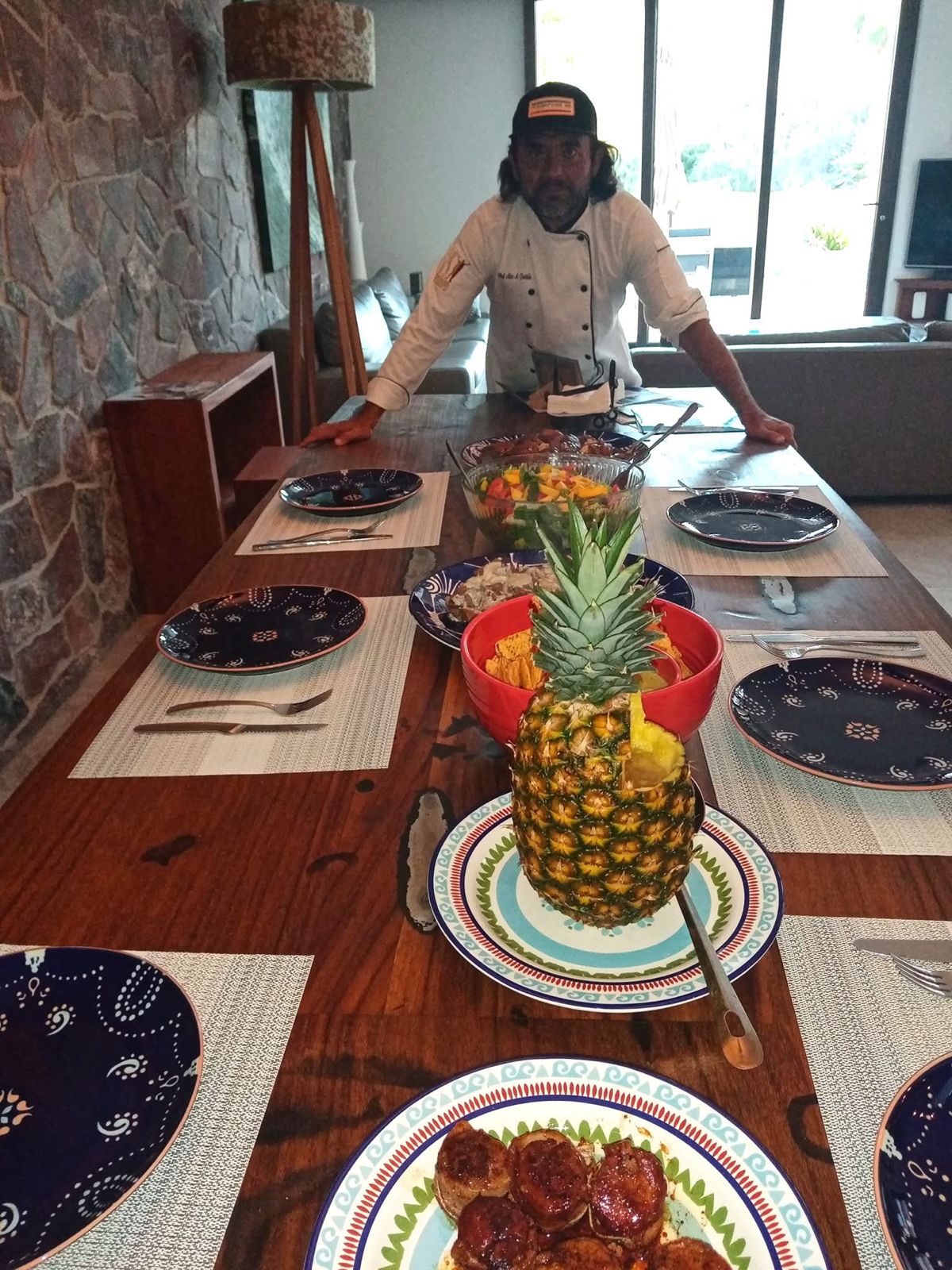 Chef Cabo Alex behind a beautifully set table at a private villa dinner